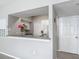 A full kitchen view with white cabinets, appliances, and a breakfast bar overlooking the main room at 5144 City St # 211, Orlando, FL 32839