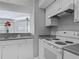 Well-lit kitchen featuring a stove, and ample cabinet space with easy access to the breakfast bar at 5144 City St # 211, Orlando, FL 32839
