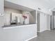 Kitchen view showcasing white cabinets, breakfast bar, and appliances in an open-concept design at 5144 City St # 211, Orlando, FL 32839