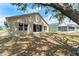 Exterior home image of the backyard; mature shade tree with the home exterior at 558 Knollwood Dr, Davenport, FL 33837