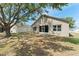 Backyard image, showing the yard, mature shade tree, and back of home at 558 Knollwood Dr, Davenport, FL 33837