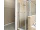 Spa-like bathroom with tiled shower enclosure and neutral color palette at 558 Knollwood Dr, Davenport, FL 33837