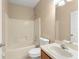 Clean bathroom with a tub, shower, vanity, and neutral tile, offering a functional space at 558 Knollwood Dr, Davenport, FL 33837