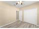 Comfortable bedroom featuring wood-look flooring, a ceiling fan, and double closet doors at 558 Knollwood Dr, Davenport, FL 33837