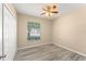 Cozy bedroom with wood-look flooring, a ceiling fan, a closet and a window letting in natural light at 558 Knollwood Dr, Davenport, FL 33837