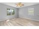Bright bedroom with gray walls, wood floors, and natural light at 558 Knollwood Dr, Davenport, FL 33837