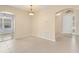 Beige dining room and entryway with modern chandelier and tiled floors at 558 Knollwood Dr, Davenport, FL 33837