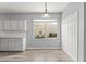 Dining room showcases natural light, neutral paint, and access to updated kitchen at 558 Knollwood Dr, Davenport, FL 33837