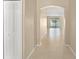 Bright hallway with neutral paint, tile flooring, and an archway leading to the living area at 558 Knollwood Dr, Davenport, FL 33837