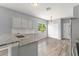 Kitchen featuring gray walls, white cabinets, and granite countertops at 558 Knollwood Dr, Davenport, FL 33837