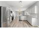 Bright kitchen with white cabinets and stainless steel appliances at 558 Knollwood Dr, Davenport, FL 33837