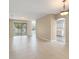 Open living area with tile floors, sliding glass doors, and access to the kitchen at 558 Knollwood Dr, Davenport, FL 33837