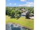 Scenic aerial view of a home with a private pool, outdoor living spaces, and access to a tranquil lake at 6313 Bordeaux Cir, Sanford, FL 32771