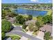 Aerial view of a house on a cul-de-sac, showcasing its brick driveway, lush landscaping and neighborhood lake views at 6313 Bordeaux Cir, Sanford, FL 32771