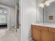 Bathroom with tile floors, single vanity, and a shower-tub combo with glass doors at 6313 Bordeaux Cir, Sanford, FL 32771