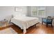 Cozy bedroom features wood floors, a bright window, and calming, neutral decor at 6313 Bordeaux Cir, Sanford, FL 32771