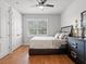 Inviting bedroom with a large window, hardwood floors, and stylish, modern furnishings at 6313 Bordeaux Cir, Sanford, FL 32771