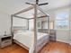 Charming bedroom with a four-poster bed, wood floors, and serene natural light at 6313 Bordeaux Cir, Sanford, FL 32771