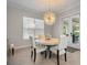 A bright dining room features a modern chandelier and access to outdoor space at 6313 Bordeaux Cir, Sanford, FL 32771