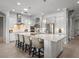 A spacious white kitchen boasts a large island with seating and pendant lighting at 6313 Bordeaux Cir, Sanford, FL 32771