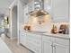 A modern kitchen features white cabinetry, stainless steel appliances, and marble countertops at 6313 Bordeaux Cir, Sanford, FL 32771