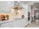 A modern kitchen features white cabinetry, stainless steel appliances, and marble countertops at 6313 Bordeaux Cir, Sanford, FL 32771
