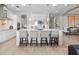 A spacious white kitchen boasts a large island with seating and pendant lighting at 6313 Bordeaux Cir, Sanford, FL 32771