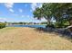 Picturesque lake view with picnic tables, lush greenery, and neighborhood houses in the background at 6313 Bordeaux Cir, Sanford, FL 32771