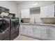 A functional laundry room features modern appliances and ample counter space at 6313 Bordeaux Cir, Sanford, FL 32771