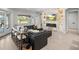 Stylish living room with a lake view, fireplace, TV, comfortable seating, and an adjacent white gourmet kitchen at 6313 Bordeaux Cir, Sanford, FL 32771