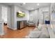 Bright living room featuring a flat-screen TV, modern furniture, and wood flooring at 6313 Bordeaux Cir, Sanford, FL 32771