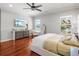 Inviting main bedroom featuring hardwood floors, a comfortable bed, natural light, and tasteful decor at 6313 Bordeaux Cir, Sanford, FL 32771