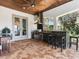 Outdoor kitchen and bar area featuring a built-in grill, bar seating, and a covered patio, perfect for entertaining at 6313 Bordeaux Cir, Sanford, FL 32771