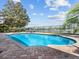 Sparkling pool with a fence, comfortable seating, and scenic water views, ideal for outdoor relaxation and entertainment at 6313 Bordeaux Cir, Sanford, FL 32771