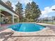 Private pool area with a view of the serene waterfront, lounge chairs, and outdoor seating under a covered patio at 6313 Bordeaux Cir, Sanford, FL 32771