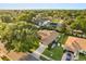 Aerial view of a single-story home surrounded by lush greenery and a sparkling pool at 652 Rochester St, Oviedo, FL 32765