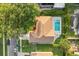 Aerial view showcases a well-maintained home with a bright blue swimming pool and patio area at 652 Rochester St, Oviedo, FL 32765