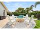 Tranquil backyard featuring a fire pit with Adirondack chairs and a refreshing pool at 652 Rochester St, Oviedo, FL 32765
