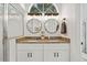Bright bathroom features a double vanity with granite countertop and a glass-enclosed shower at 652 Rochester St, Oviedo, FL 32765