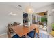 Dining area with a sliding door, stylish light fixture and serving cart at 652 Rochester St, Oviedo, FL 32765