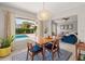 Dining area with view of backyard pool, stylish light fixture and modern decor at 652 Rochester St, Oviedo, FL 32765