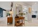 Inviting entryway with wood console table, decorative mirror and stylish decor leading into a bright, open-concept home at 652 Rochester St, Oviedo, FL 32765