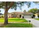 Charming single-story home featuring a well-manicured lawn and colorful flower beds enhancing its curb appeal at 652 Rochester St, Oviedo, FL 32765