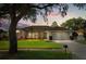Charming single-story home featuring a well-manicured lawn and colorful flower beds enhancing its curb appeal at 652 Rochester St, Oviedo, FL 32765