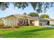 Charming single-story home featuring a well-manicured lawn and colorful flower beds enhancing its curb appeal at 652 Rochester St, Oviedo, FL 32765