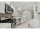 Bright kitchen with stainless steel appliances and white cabinets at 652 Rochester St, Oviedo, FL 32765