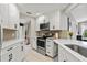 Bright kitchen featuring stainless steel appliances and updated white cabinets at 652 Rochester St, Oviedo, FL 32765