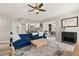 Cozy living room with a blue sectional sofa, patterned rug, and modern decor at 652 Rochester St, Oviedo, FL 32765