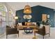 Stylish living room with high ceilings, unique lighting, comfortable seating, and a statement wall for a modern feel at 652 Rochester St, Oviedo, FL 32765