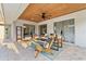 Relaxing covered patio features wood ceiling, fan, and comfortable seating overlooking the backyard at 652 Rochester St, Oviedo, FL 32765
